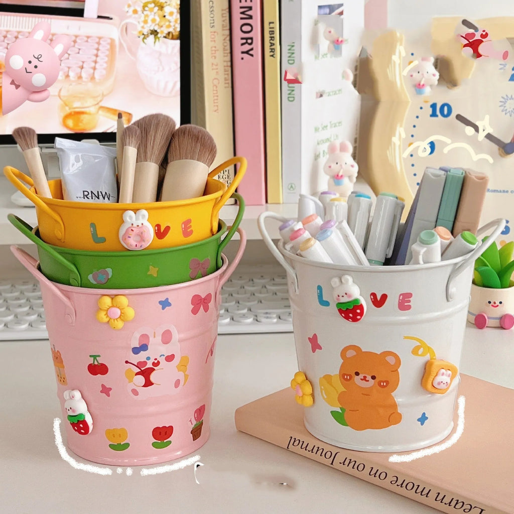 Round metal desktop pen holder in a choice of colours including green, pink, red, white, and yellow.