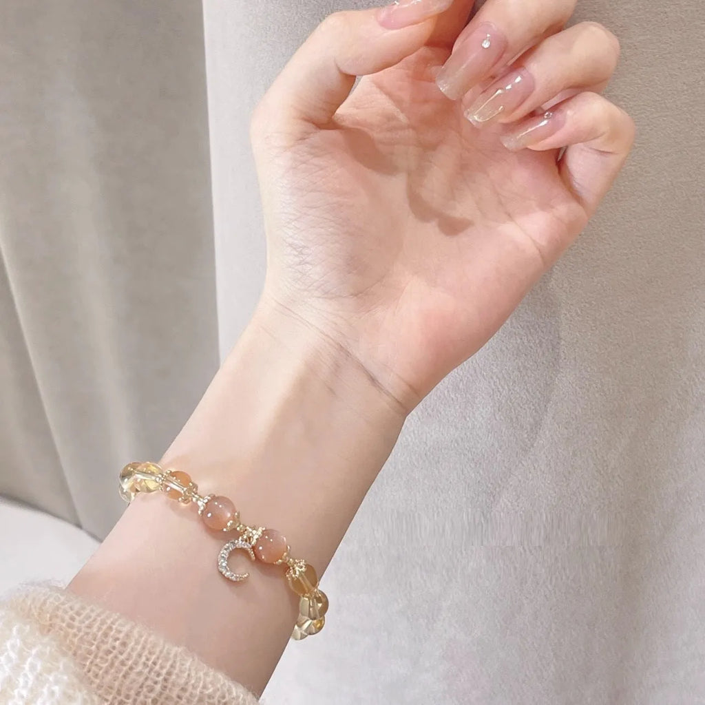 Moonstone crystal bracelet with 14K gold electroplating and diamond-shaped citrine beads on adjustable band