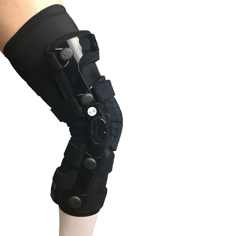 Black anterior ligament knee pad with visible metal stabiliser, shown in a left-leg size.