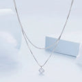 Close-up of a women's double-layer pearl chain sterling silver necklace with a matching pendant.