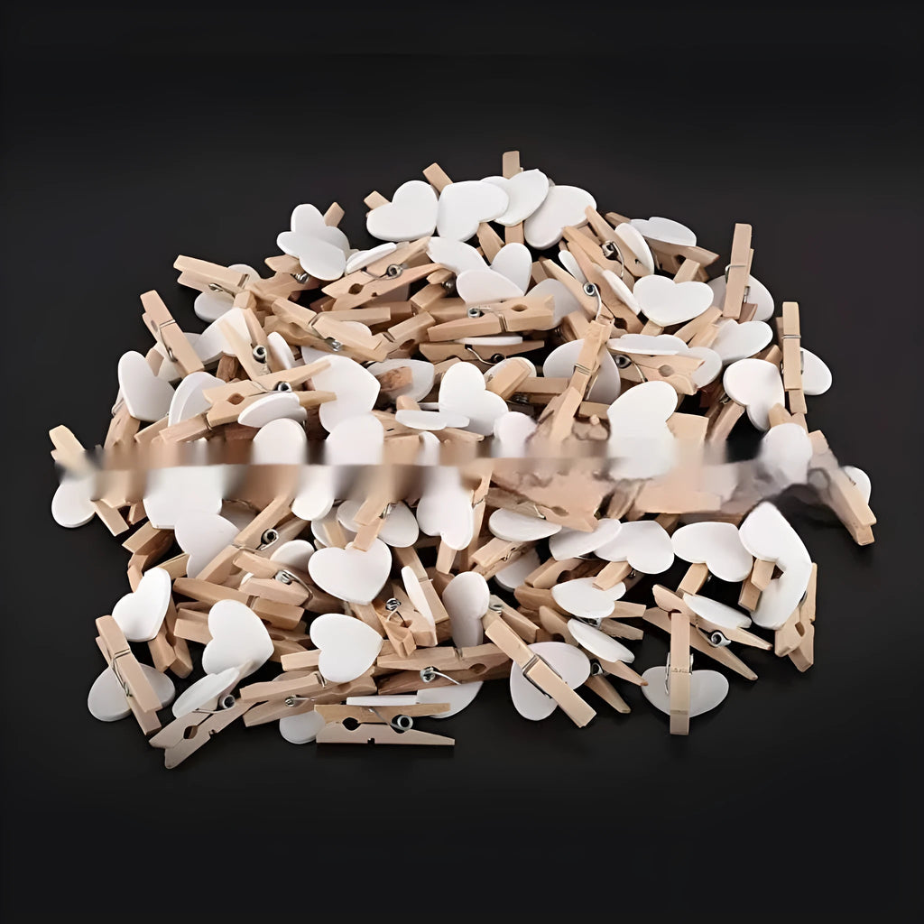 Set of five handmade solid wood heart-shaped clips in red, rose red, and white colours on a plain background.