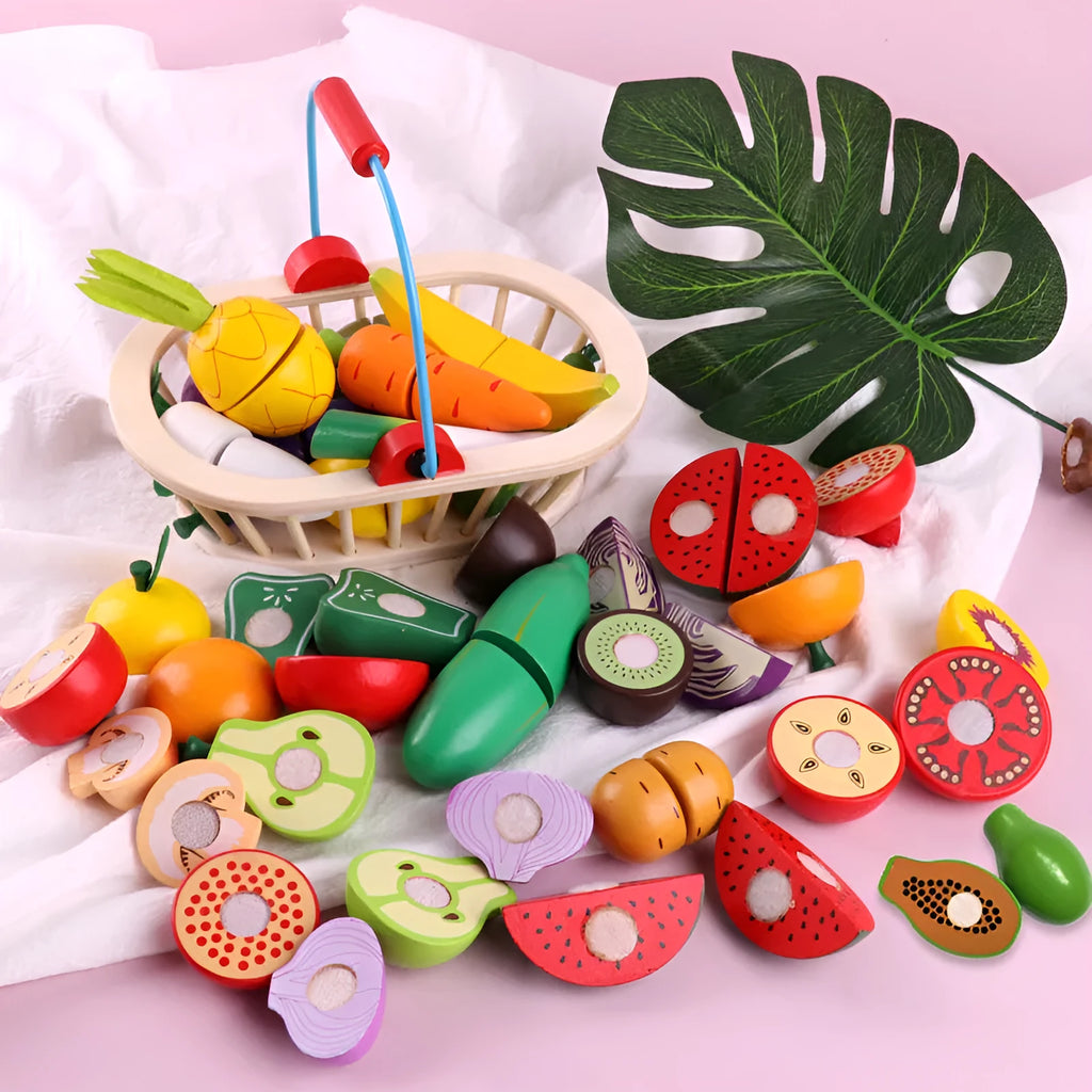 Wooden magnetic play fruit and vegetable cutting toy set on a table, including apple, banana, carrot, and more.