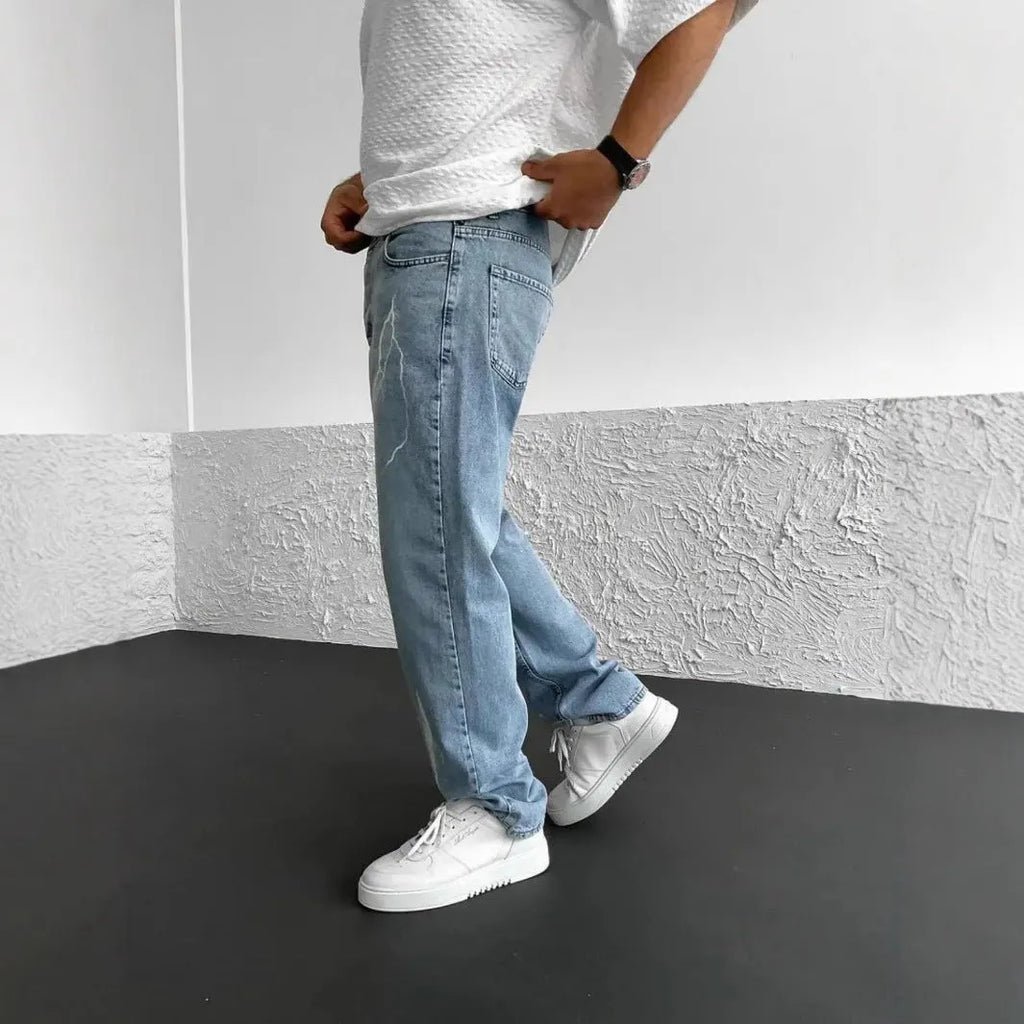 Men's blue straight-leg denim jeans with mid waist and zipper fly on solid background