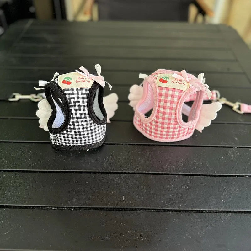 Pink adjustable cotton dog harness with chest and back handle on a small dog.