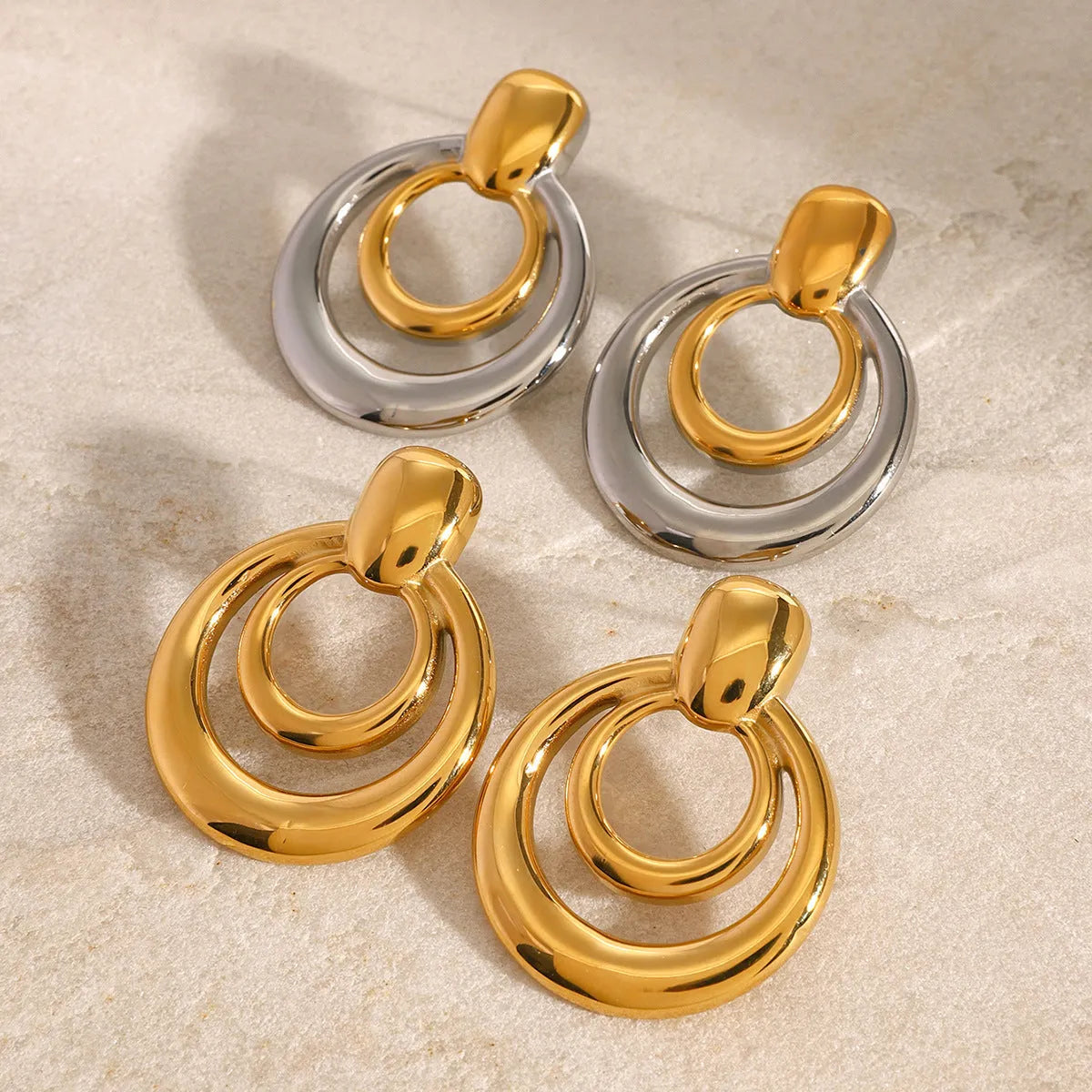Golden round double layer hollow stud earrings with geometric design and 18K gold electroplating