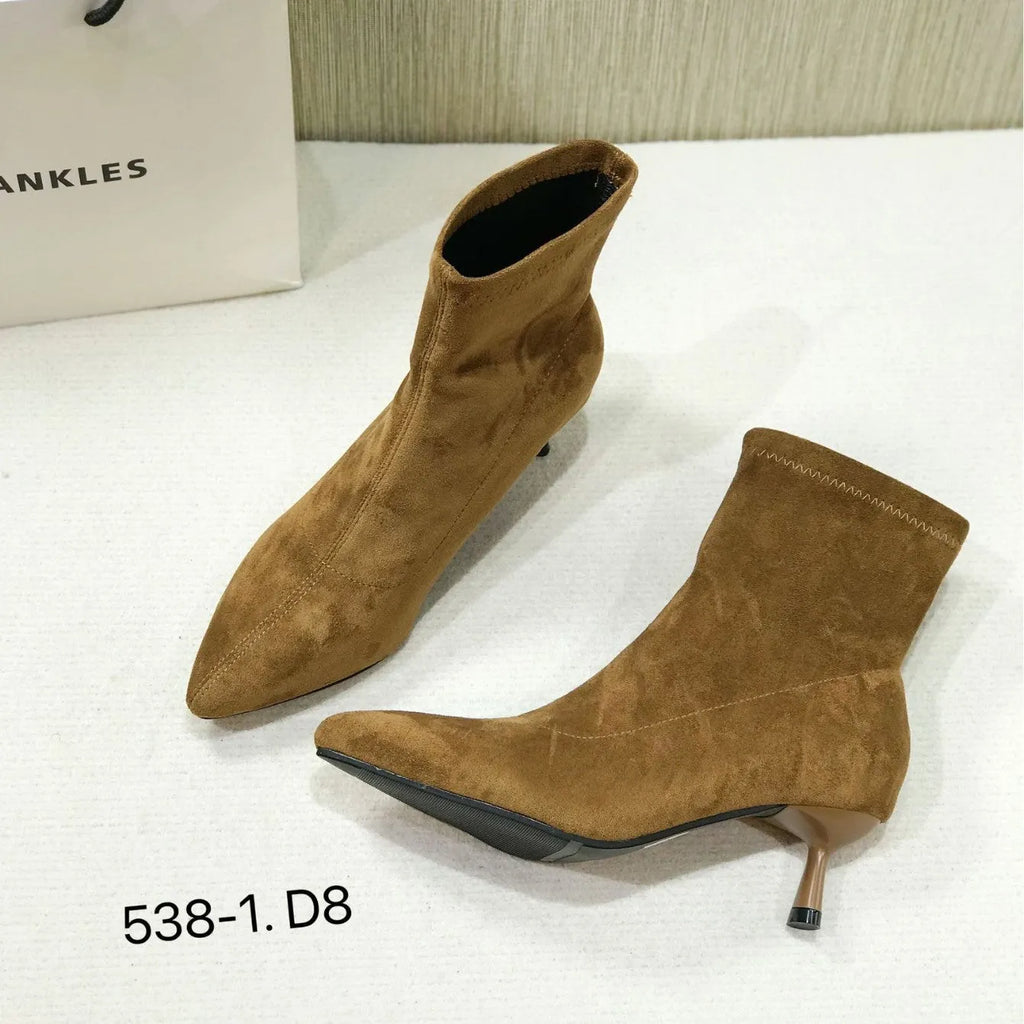 Women's black pointed toe ankle boots with a stiletto heel on a rubber sole.