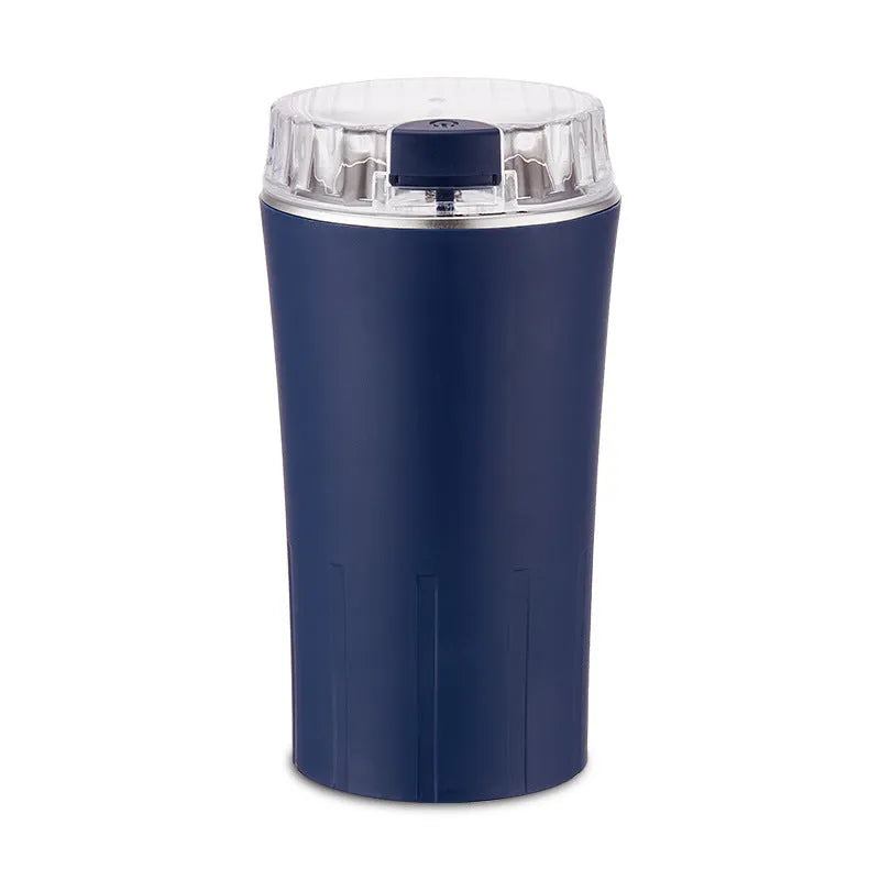 Blue stainless steel mini flour mill and grain grinder machine on a kitchen countertop.