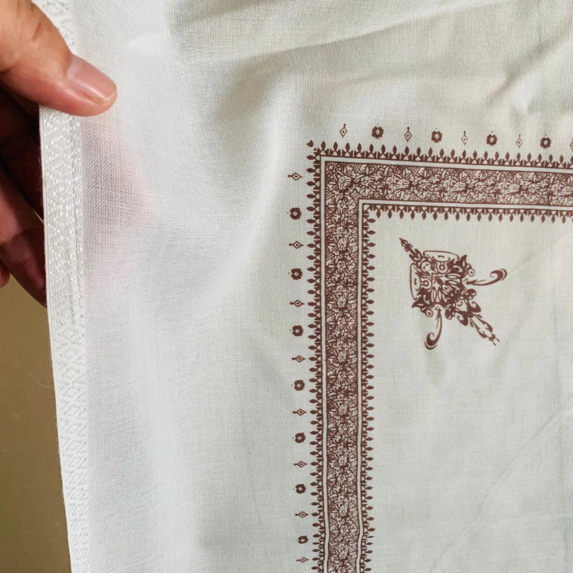 A large brown printed square polyester scarf laid flat, showing its 138x138 cm size.
