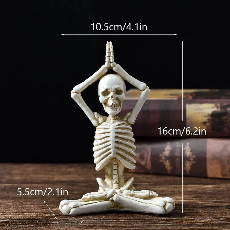 A detailed resin desktop ornament of a yoga-pose skeleton skull in black and white colour options.