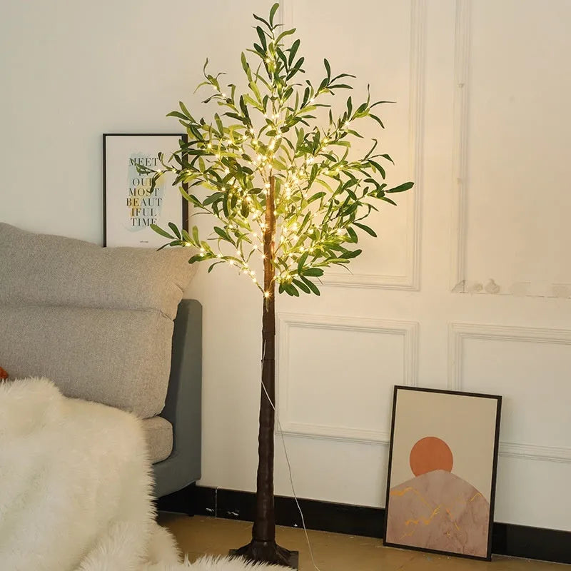 Tall 1.8 metre simulation olive leaf tree lamp with warm white LEDs lit, showing abstract trunk design.