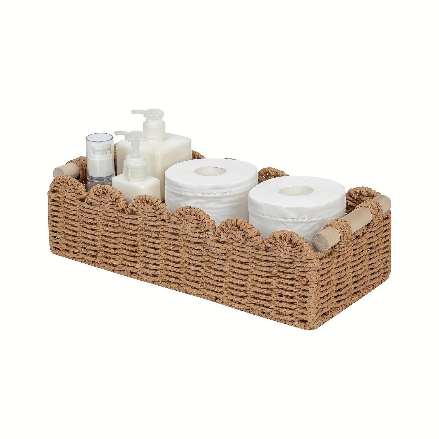 Woven paper storage basket in khaki colour on a desktop holding remote controls and pens.