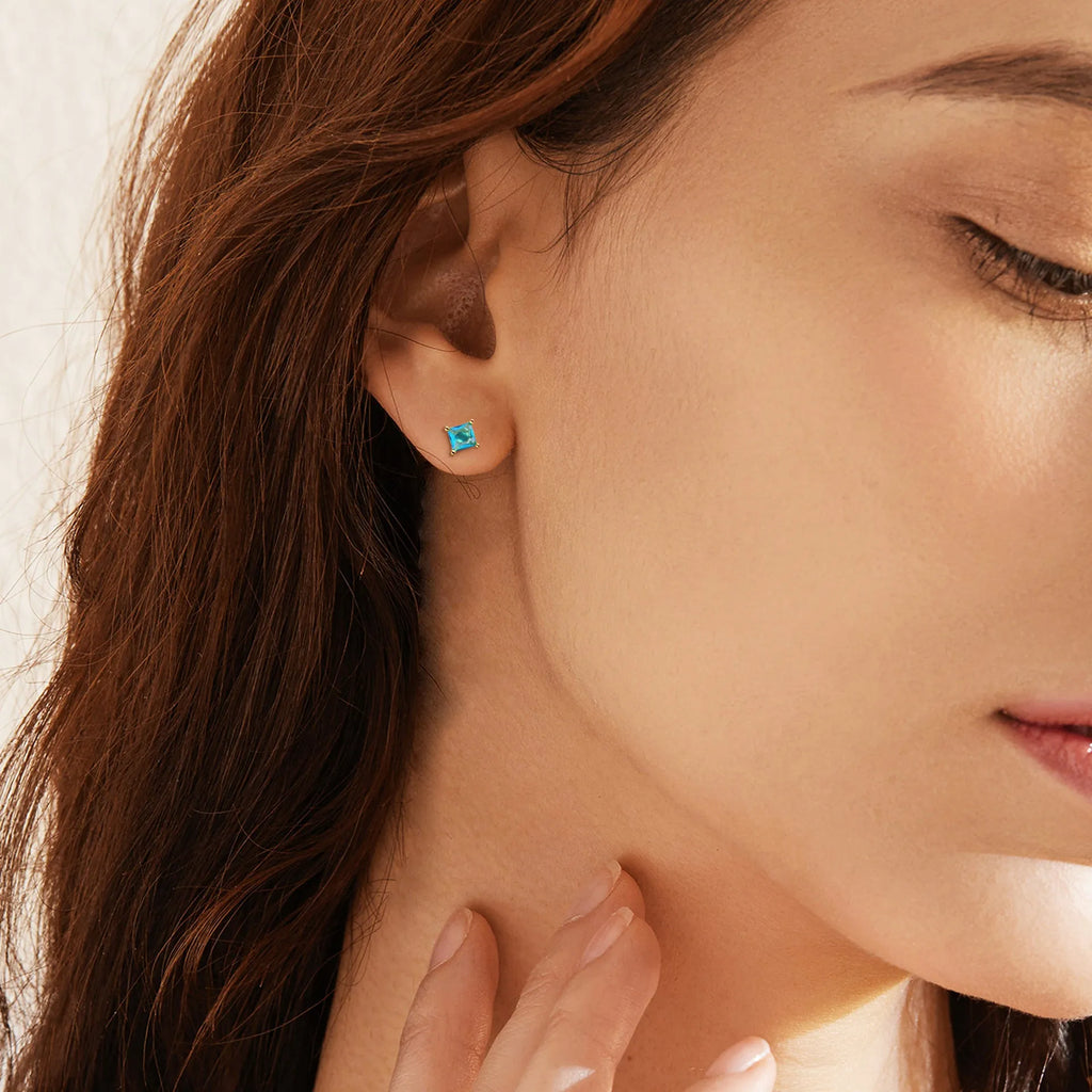 A pair of gold-plated drop earrings with a candy-colour pear-shaped zircon stone.