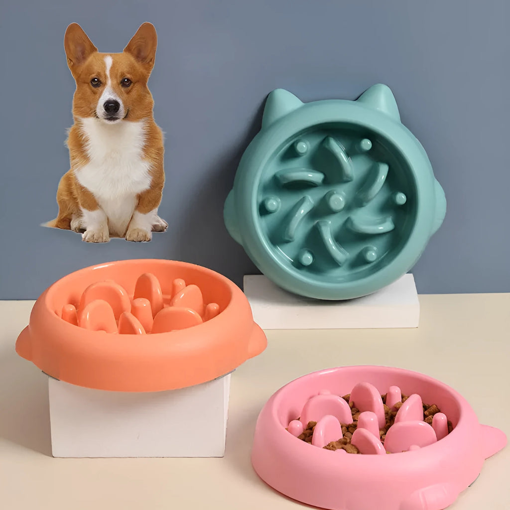 Bone-shaped slow feeder dog bowl with maze pattern in green, pink, or orange colours