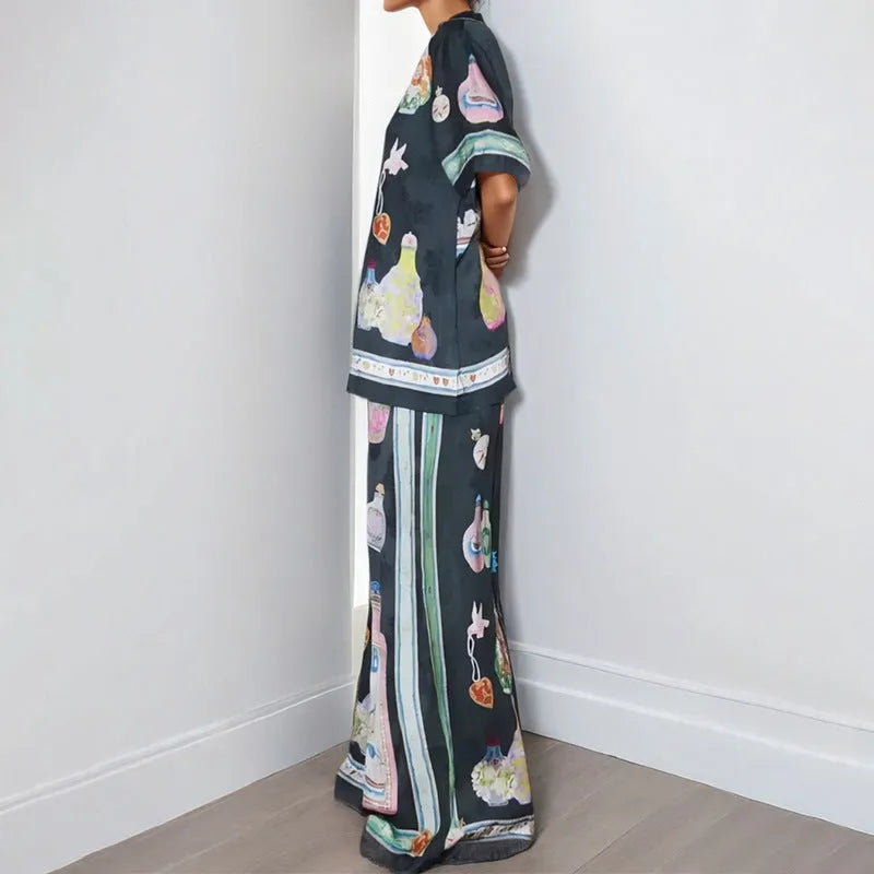 Black women's casual set with anime cartoon print, featuring a long sleeve cardigan and matching trousers.