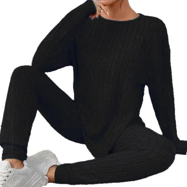 Black sunken stripe pattern two-piece loungewear set with regular sleeves on a hanger.