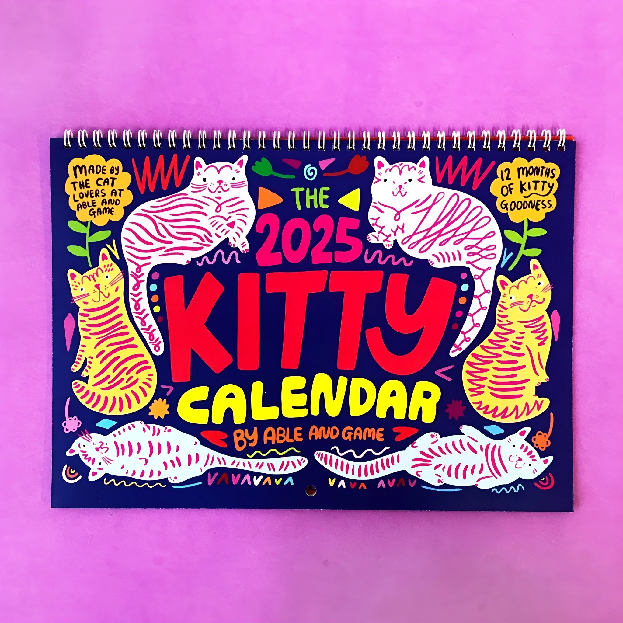Cat-themed A3 size paper wall calendar for 2024 or 2025, shown hung on a wall.