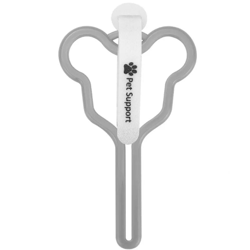 A hands-free dog poop bag holder with a fixed clip and adjustable black Velcro strap, shown attached to a dog lead.
