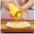 Yellow manual corn thresher kitchen tool with corn-shaped design for removing kernels.