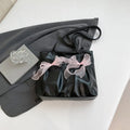 Black college-style tote bag with large capacity, a bow detail, and two shoulder straps.