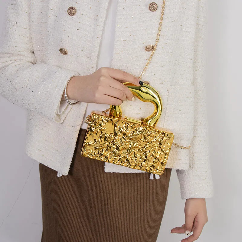 Mini crossbody bag with hard acrylic shell, chain strap, and phone pocket in Golden Ripples colour