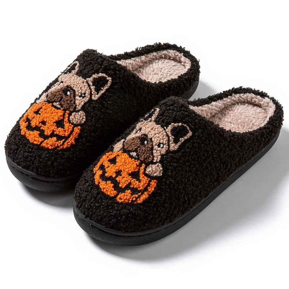 Black and white Halloween slippers with pumpkin design featuring plush uppers and non-slip rubber soles.