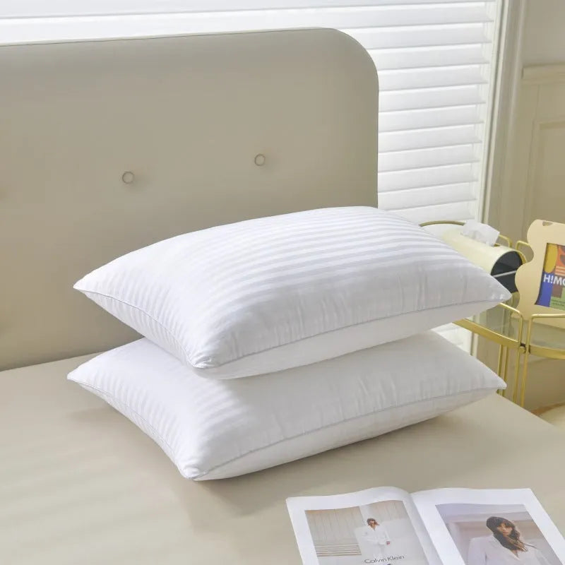 White hotel pillow with a satin stripe on a bed, showing low, medium, and high loft options.