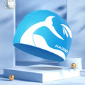 Silicone swimming cap with ear protectors in whale tail pattern, shown in black, blue, pink, and grey.