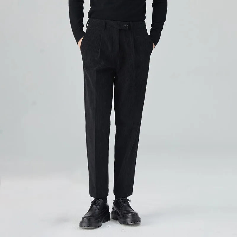 Men's straight-leg corduroy trousers in beige on a hanger, showing the textured fabric and mid-waist design.