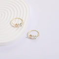 Geometric triangle copper ring with horse eye motif, tricolor zircon, and gold electroplate finish.