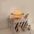Moon Earth Maglev atmosphere night light with floating planets and astronaut figures on a shelf.