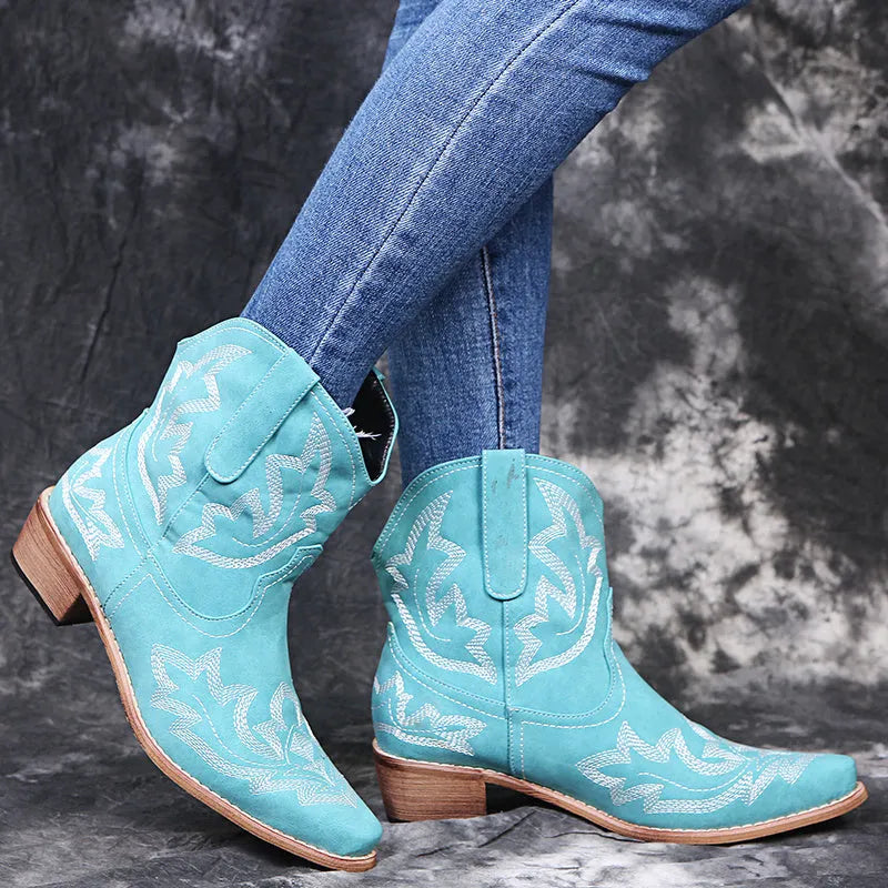 Blue women's cowboy boots with embroidery detail, wedge heel, and pointed toe.