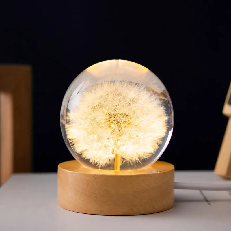 Dandelion crystal ball night light with wooden base, showing preserved flowers inside a 6cm resin sphere.