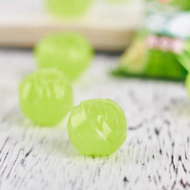 Assorted hard candies in plum, guava, and tangerine peel flavours in a bag.