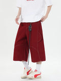 Retro multi-pocket denim workwear shorts in wide leg cropped design shown in red and black colours