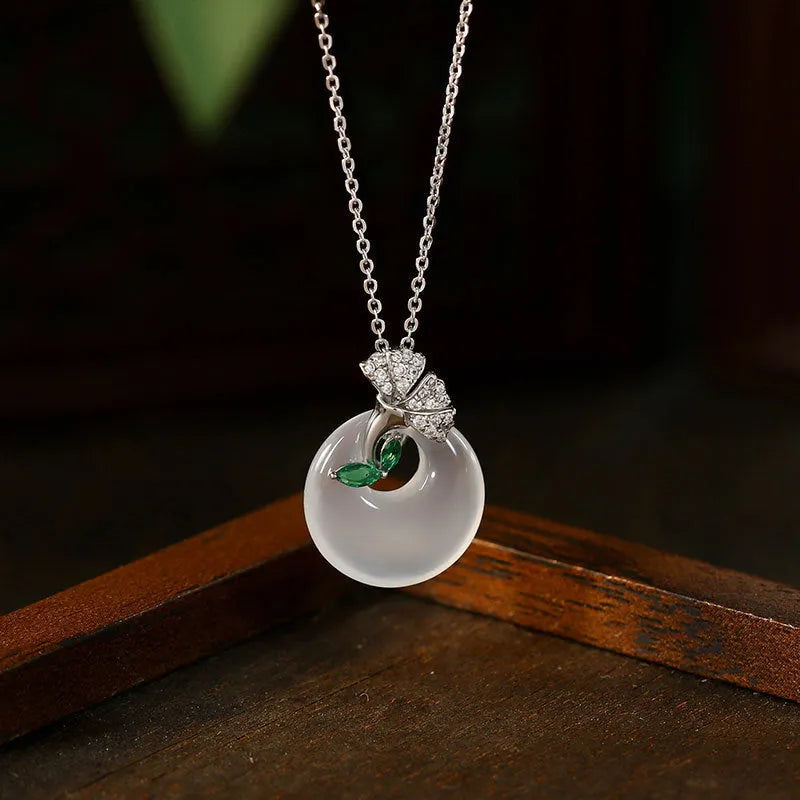 White ginkgo leaf pendant necklace with mixed gem inlay on silver electroplated O-ring chain