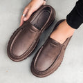 Men's black slip-on casual shoes with a waterproof platform sole and round toe.