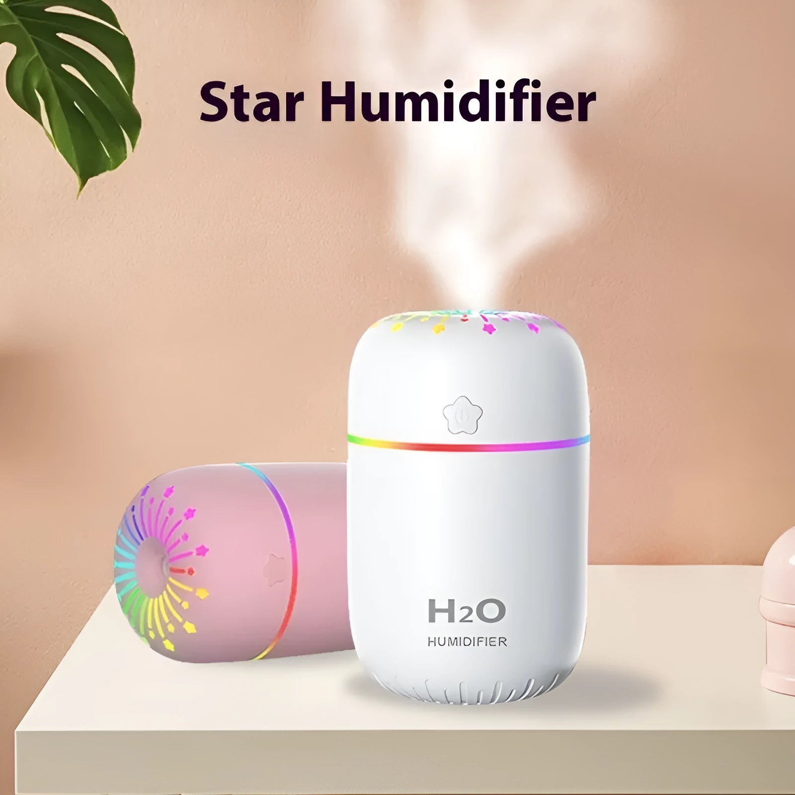 White USB mini humidifier with water tank on a desk next to a laptop