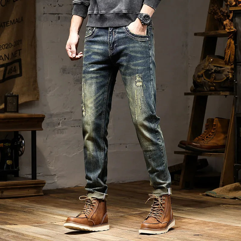 Men's slim-fit jeans in a retro colour with a zip fly, shown laid flat.