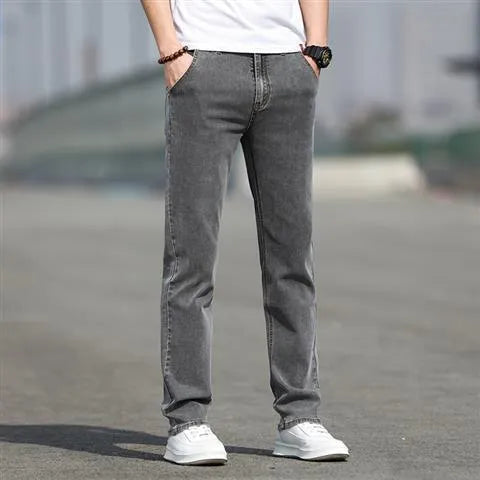 Man wearing smoky grey straight leg jeans with low waist and zipper fly.