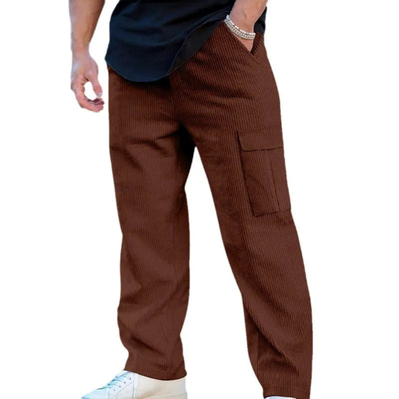 Men's navy blue corduroy cargo trousers with a drawstring waist and straight legs laid flat.