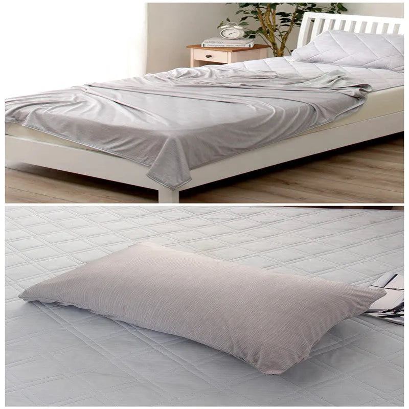 Blue and grey polyester cooling blanket with Japanese Q-Max fibres on a bed.