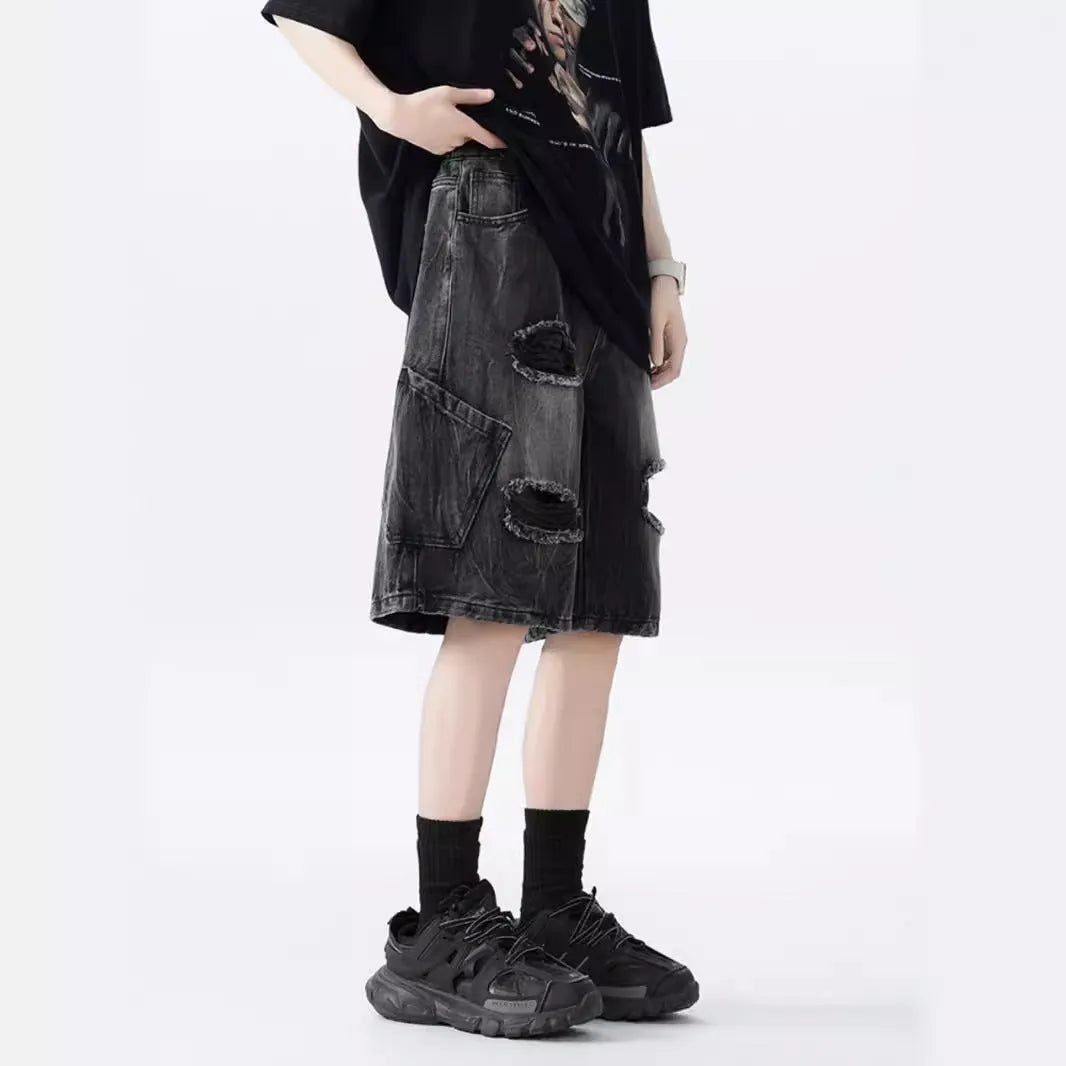 Men's loose fit distressed denim shorts in black vintage style with ripped detailing