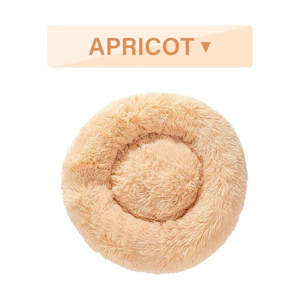 Fluffy donut-shaped dog bed in light grey plush material, showing raised rim and central cushion.