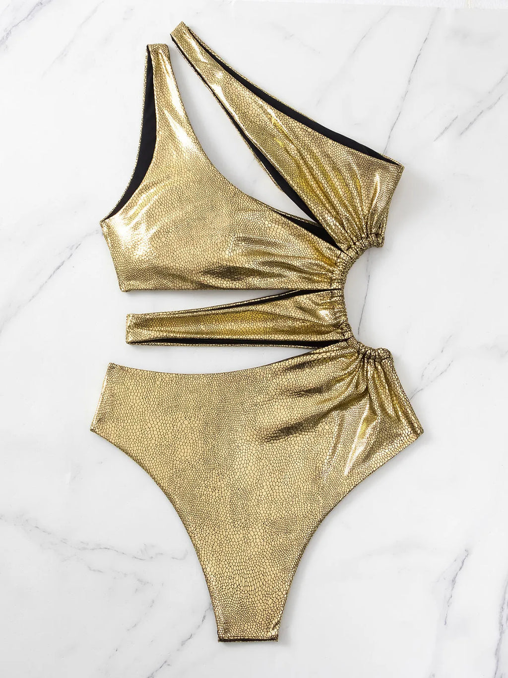 Women's gold backless one-piece swimsuit on a model, showing spandex material and solid colour design.