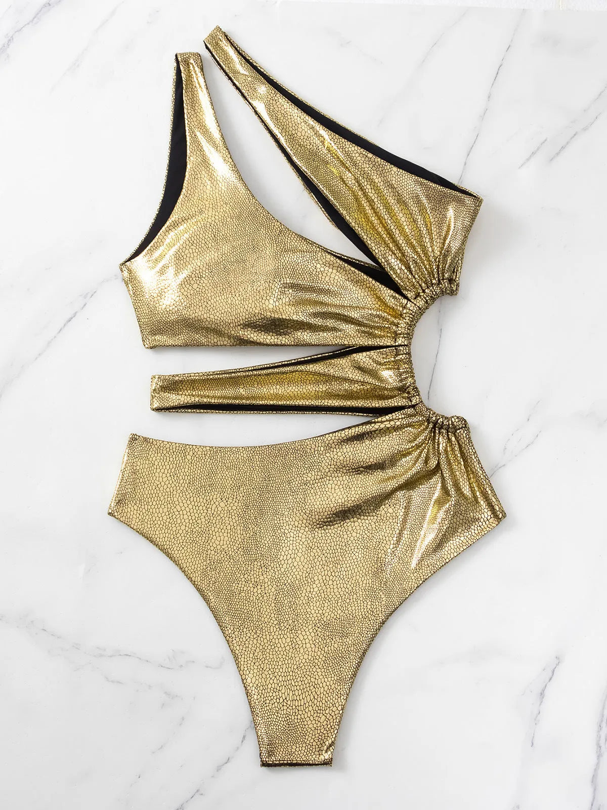 Women's gold backless one-piece swimsuit on a model, showing spandex material and solid colour design.