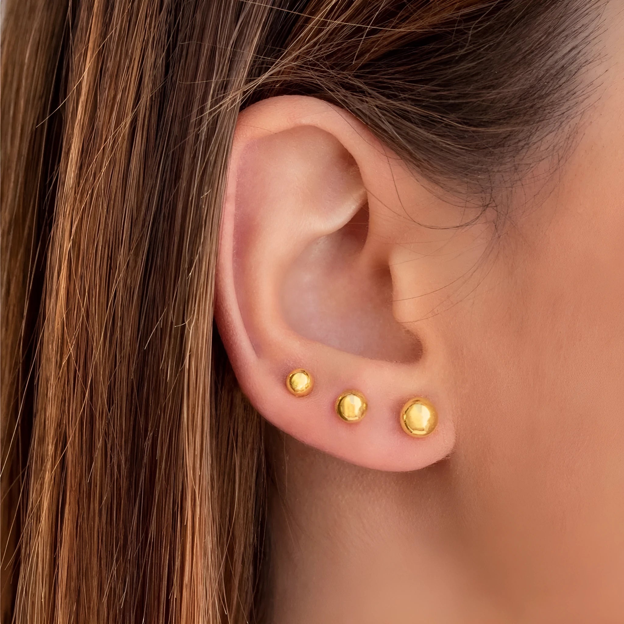 Stainless steel ball stud earrings with gold or silver electroplating in minimalist geometric design.