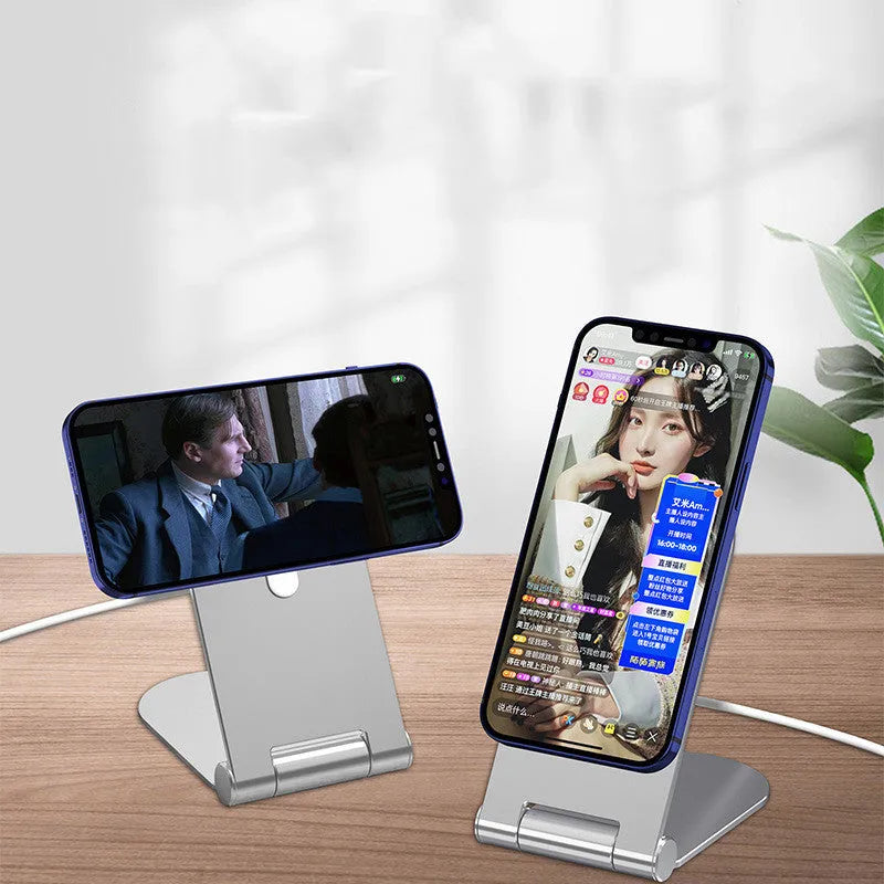 Silver vertical aluminium alloy magnetic phone bracket for iPhone 12 on a table.