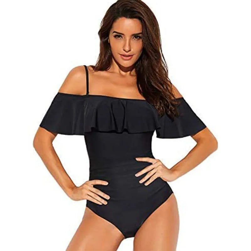 Black one-piece swimsuit with cut-out design and ruffled straps laid flat.