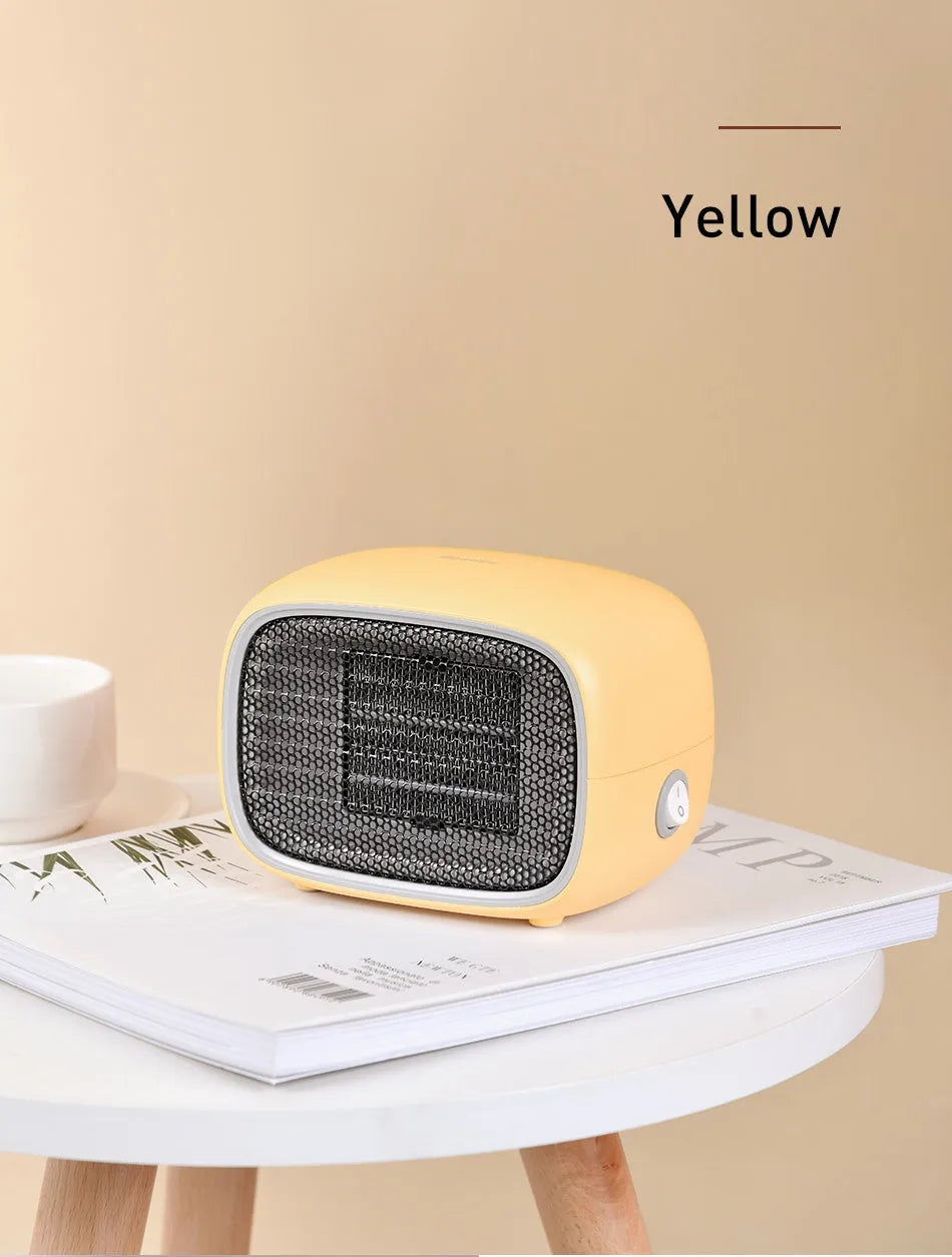 Green mini PTC ceramic heater showing compact size and metal mesh grille.