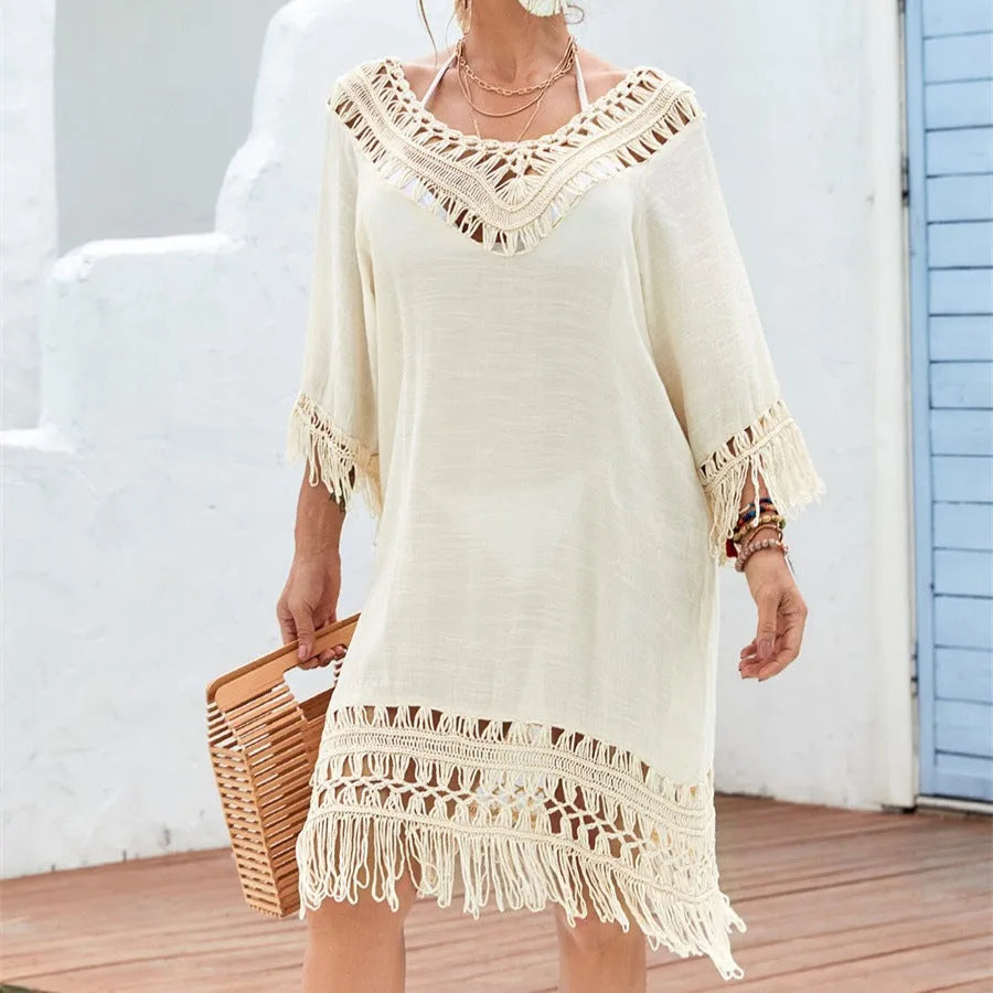 Apricot-coloured women's crocheted patchwork beach dress with half sleeves on a hanger.